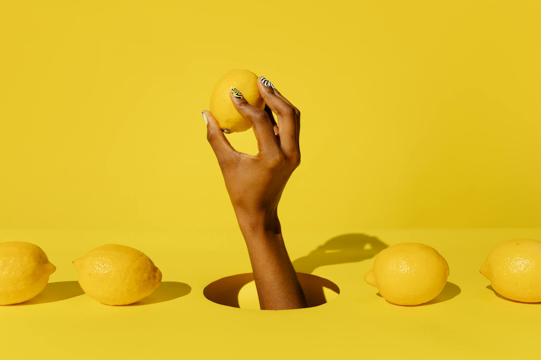 Woman holding a lemon, representing fresh reconnection and natural pleasure