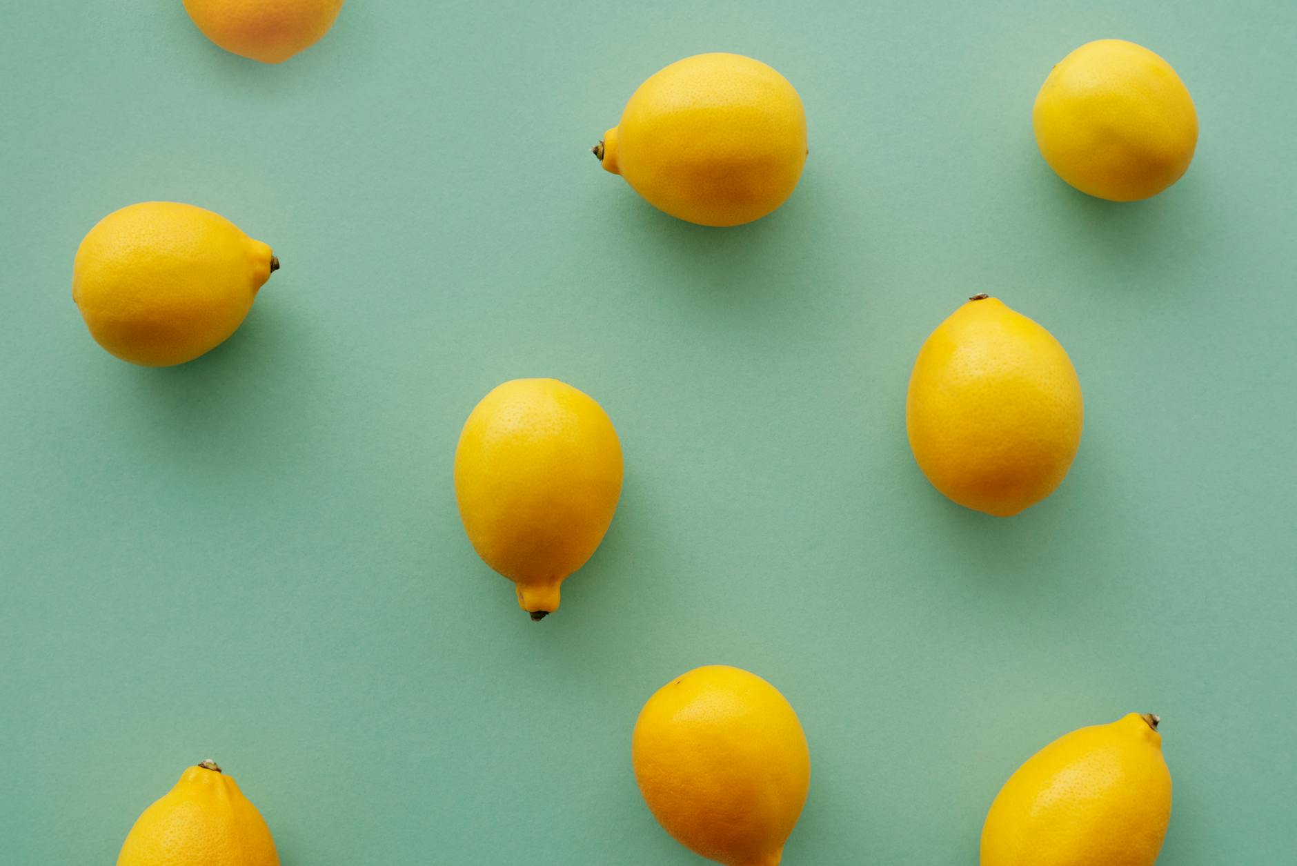 Bright yellow lemons arranged on a soft green background, symbolizing fresh starts and gentle renewal.