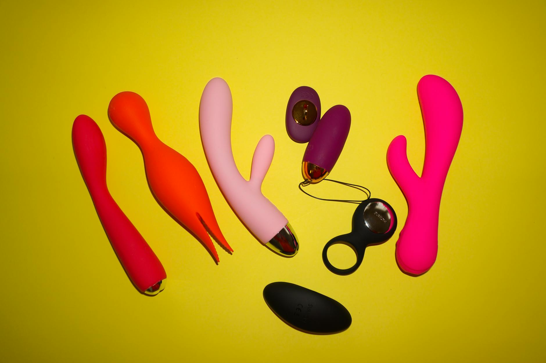 Colorful clitoral vibrators displayed on a bright background