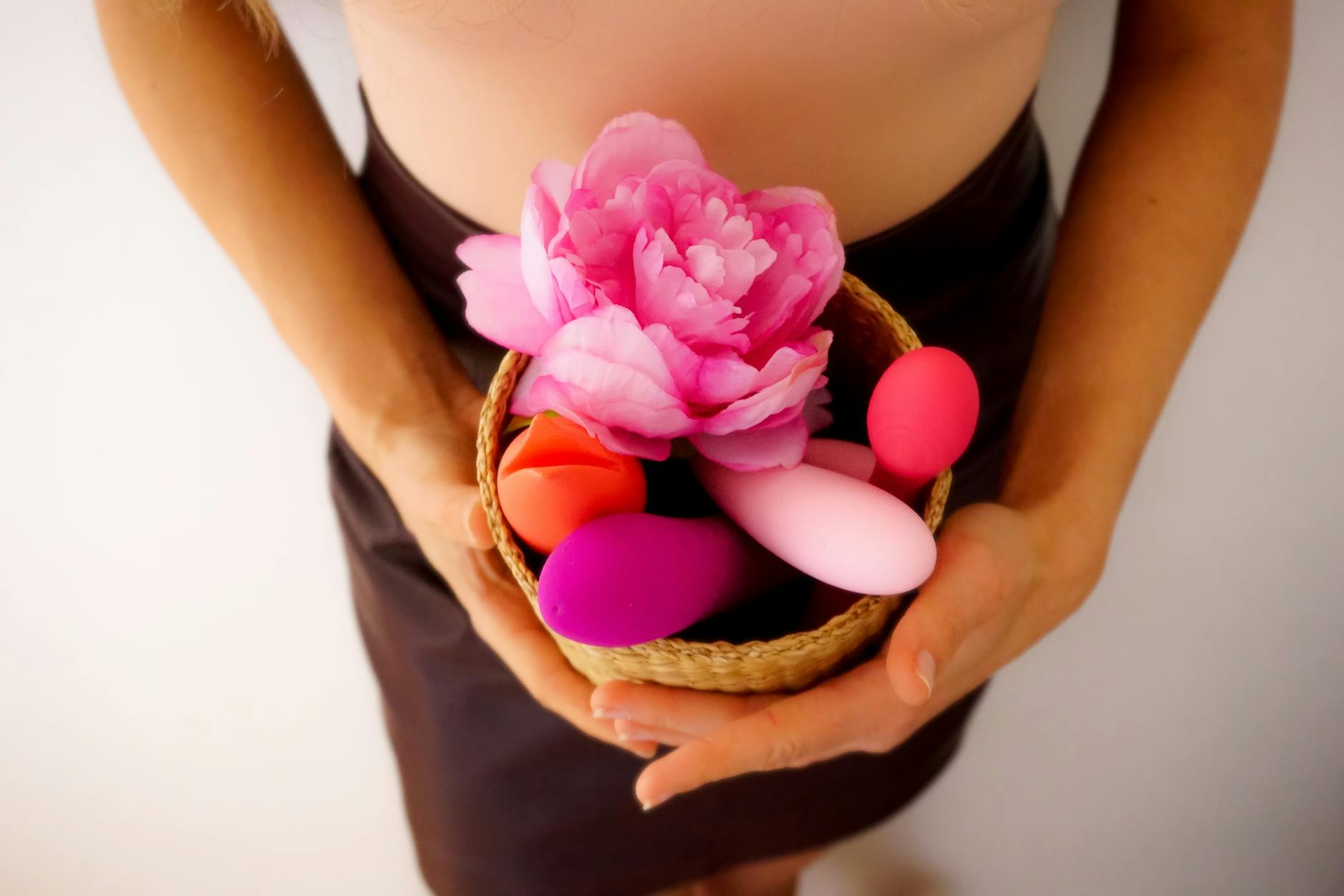 Intimate hands holding a vibrator together, representing rekindled connection
